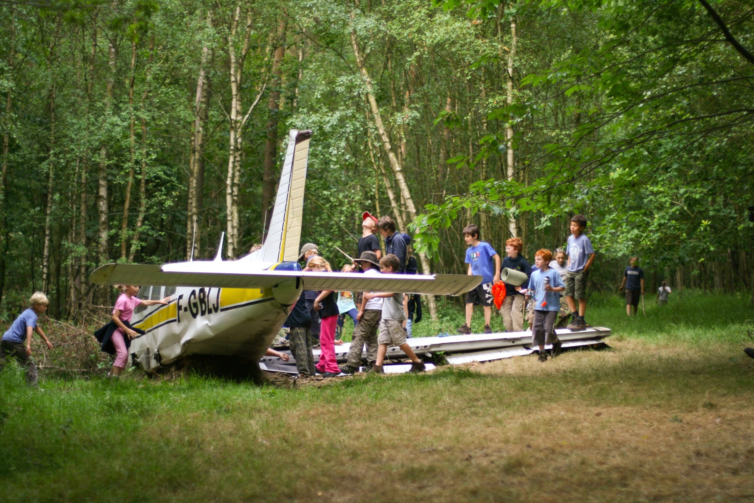 Students exploring the plane wreck during the Scenario SOS team challenge
