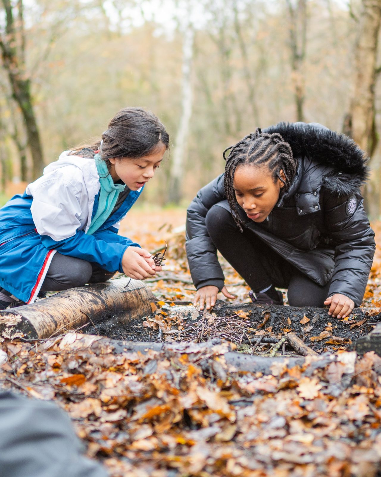 Year 7 students lighting a campfire on an autumn school trip